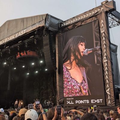 The singer Beabadoobee on a big screen next to the stage.