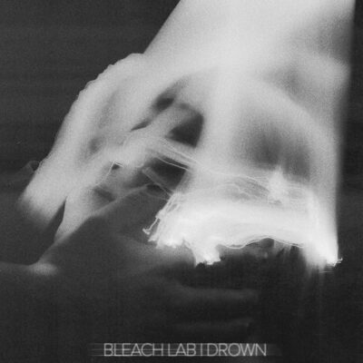 Bleach Lab - Drown. An abstact black and white photograph of a hand with light blurs.